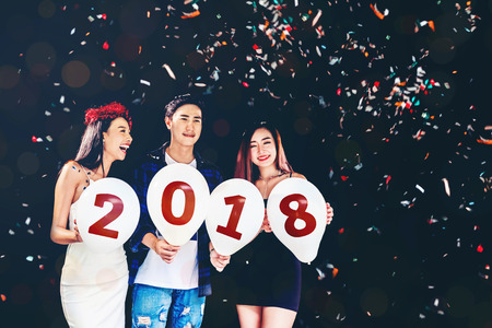 Newyear party ,celebration party group of asian young people holding balloon numbers 2018 happy and funny conceptの写真素材