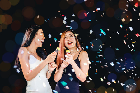 celebration party group of asian young woman and confetti happy,funny conceptの写真素材