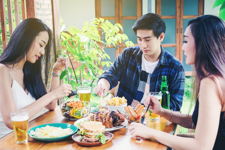 Group Friends young asian people Party and eating food happy enjoying in homeの写真素材