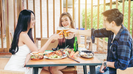 Group of young asian people celebrating beer festivals happy while enjoying home partyの写真素材