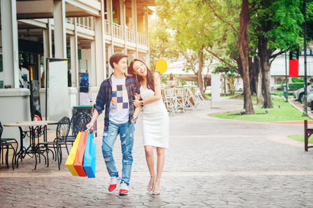 Asian Couple Enjoying Romance Spending shopping bags Fashion shopping streetの写真素材
