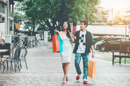 Asian Couple Enjoying Romance Spending shopping bags Fashion shopping streetの写真素材