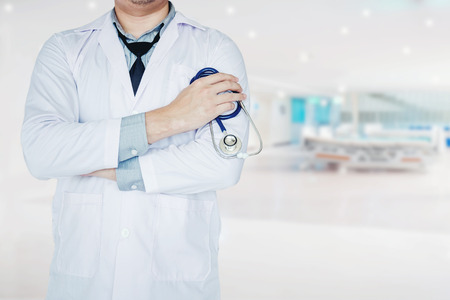 Doctor holding a stethoscope on background of Hospital wardの写真素材