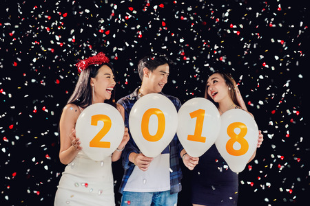 Newyear party ,celebration party group of asian young people holding balloon numbers 2018 happy and funny conceptの写真素材