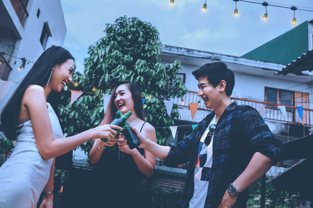 Group of young asian people happy while enjoying Night party on garden homeの写真素材