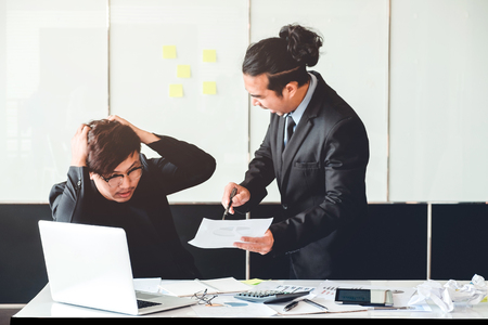Asian Bad angry boss yelling at employeeの写真素材