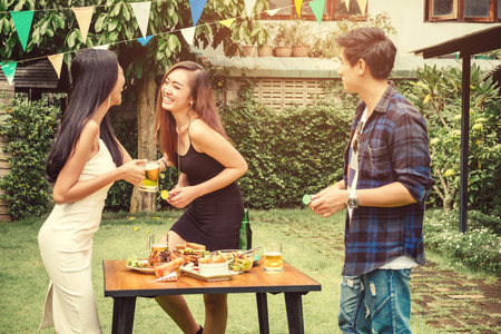 Group of young people Party happy while enjoying home party on garden homeの写真素材