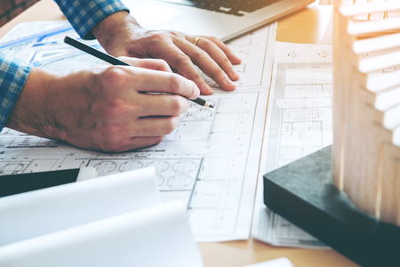 Architect or engineer working in office on blueprint. Architects workplaceの写真素材