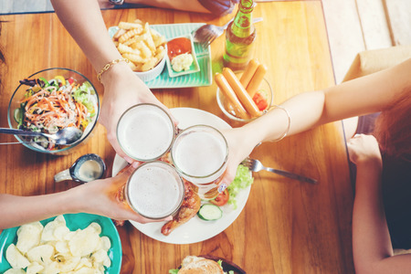 Group of young asian people celebrating beer festivals happy while enjoying home partyの写真素材