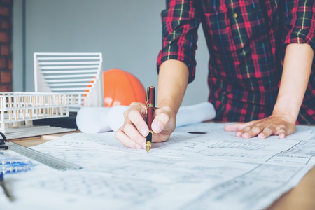 Architect or engineer working in office on blueprint. Architects workplaceの写真素材
