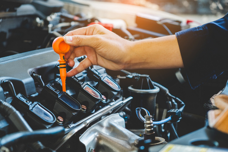 Car Engine oil mechanic working in auto repair serviceの写真素材