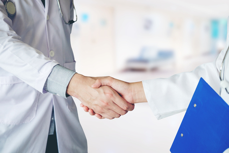 Two Doctor is talking and handshake in the hospital.の写真素材