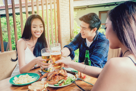 Group friend young asian people celebrating beer festivals happy while enjoying home partyの写真素材