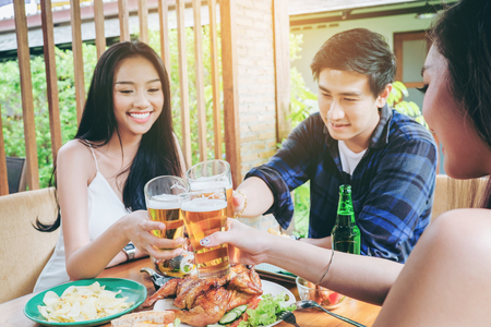 Group friend young asian people celebrating beer festivals happy while enjoying home partyの写真素材