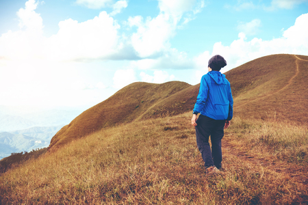 Tourist trail hiking in the forest Traveler Man crossing the mountain Traveler conceptの写真素材