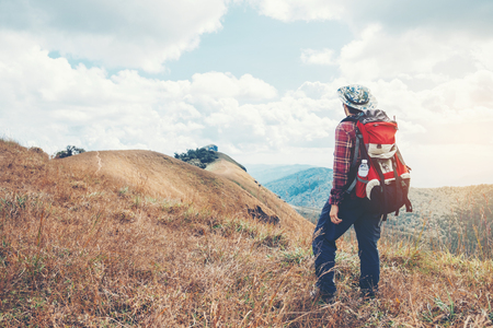 Tourist trail hiking in the forest Traveler Man with backpack crossing the mountainの写真素材