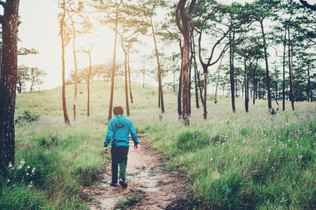 Tourist trail hiking in the forest Traveler Man with backpack crossing the mountainの写真素材