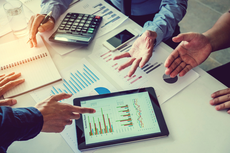 Business team meeting working on digital tablet new business projectの写真素材