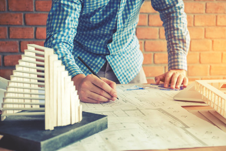Architect or engineer working in office on blueprint. Architects workplaceの写真素材