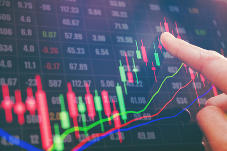 Businessman writing the trading graph of stock market on digital stock market financial exchange and Trading graphの写真素材