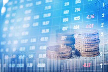 Graph on rows of coins for finance and banking on digital stock market financial exchange and Trading graph Double exposure city on the backgroundの写真素材