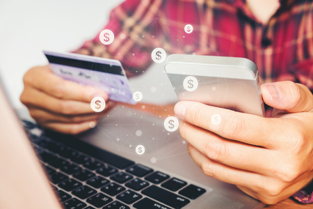 Online banking businessman using smartphone with credit card Fintech and Blockchain conceptの写真素材