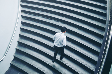 Successful businessman running fast upstairs Success conceptの写真素材
