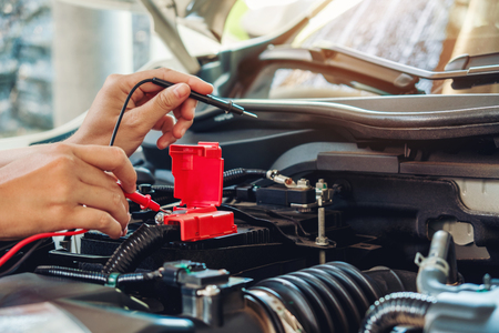 Hands of car mechanic working in auto repair service.の写真素材