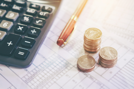 Calculator and coin on the business paper. Report chartの写真素材