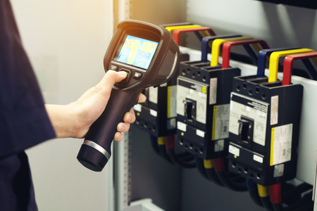 Technician use thermal imaging camera to check temperature in factoryの写真素材