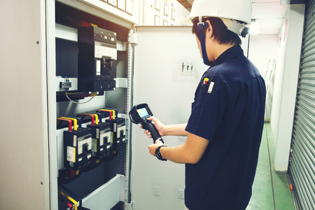 Technician use thermal imaging camera to check temperature in factoryの写真素材