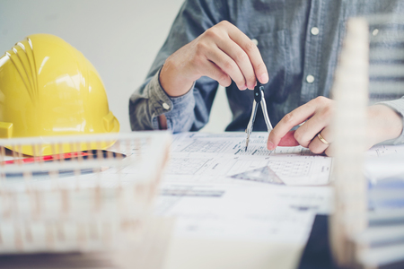 Architect or engineer working in office on blueprint. Architects workplaceの写真素材