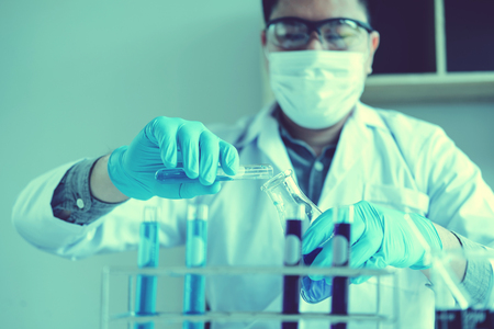 Scientist with equipment holding tools during scientific experiment science conceptの写真素材