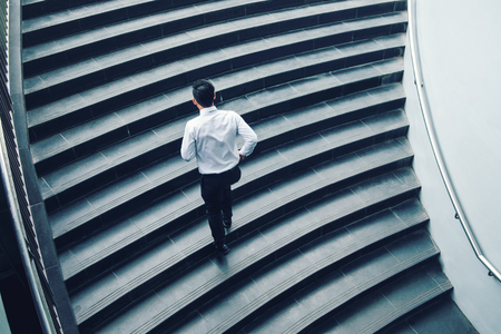 Businessman running fast upstairs Growth up Success conceptの写真素材