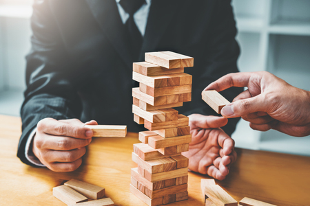 Two Businessman plan and strategy in business Domino Effect Leadership Management Solution conceptの写真素材