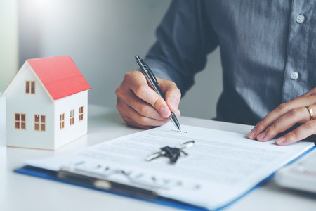 Business man calculated cost and  sign agreement contract, Insurance Home conceptの写真素材