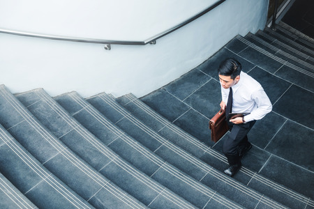 Businessman running fast upstairs Growth up Success conceptの写真素材