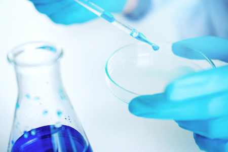 Scientist with equipment holding tools during scientific experiment science conceptの写真素材