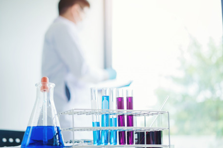 Scientist with equipment holding tools during scientific experiment science conceptの写真素材