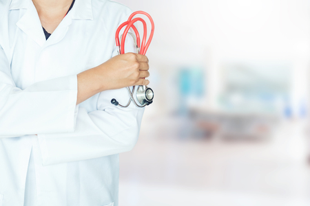 Doctor holding a stethoscope on background of Hospital wardの写真素材