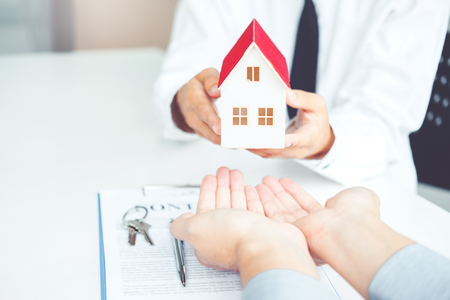 Sale agent giving house to customer and sign agreement contract, Insurance Home conceptの写真素材