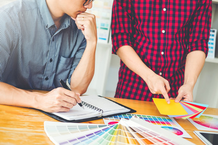 Two Graphic designer Brainstorming Meeting and drawing on graphics tablet at workplaceの写真素材