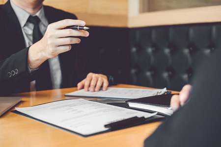 Senior manager reading a resume during a job interview employee young man meeting Applicant and recruitment conceptの写真素材