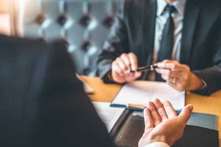 Senior manager reading a resume during a job interview employee young man meeting Applicant and recruitment conceptの写真素材