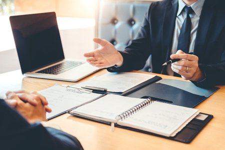 Senior manager reading a resume during a job interview employee young man meeting Applicant and recruitment conceptの写真素材