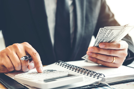 Business man Accounting Calculating Cost Economic budget investment and saving conceptの写真素材