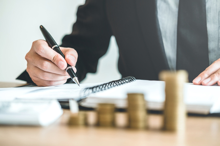 Business man Accounting Calculating Cost Economic budget investment and saving conceptの写真素材