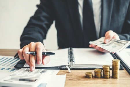 Business man Accounting Calculating Cost Economic budget investment and saving conceptの写真素材