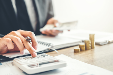 Business man Accounting Calculating Cost Economic budget investment and saving conceptの写真素材