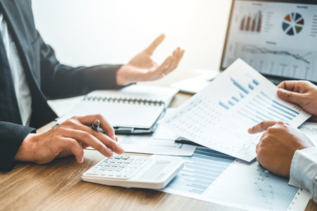 Co-working Business Team meeting Planning Strategy Analysis investment and saving concept. meeting discussing new plan financial graph data.の写真素材